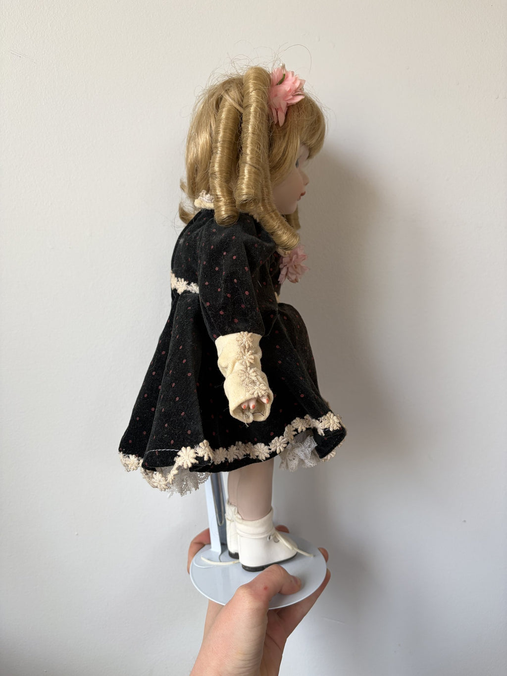 Vintage Porcelain Doll with Blonde Curls and Black Dress