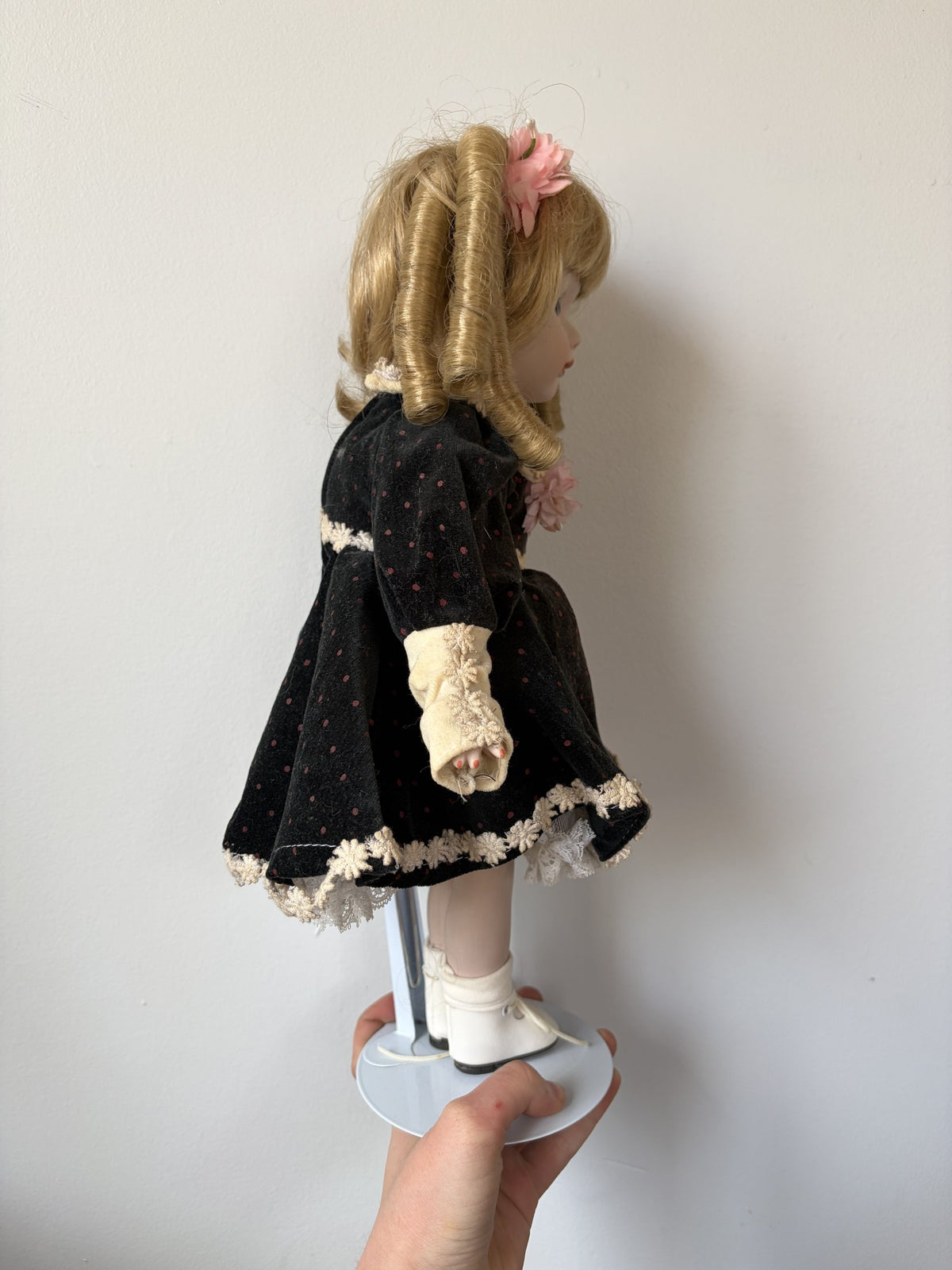 Vintage Porcelain Doll with Blonde Curls and Black Dress