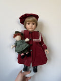 Porcelain Doll in Burgundy Outfit with Doll Accessory