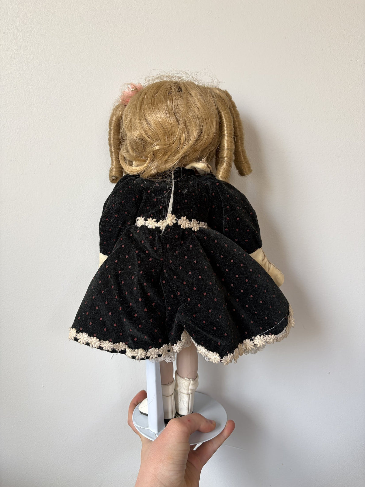 Vintage Porcelain Doll with Blonde Curls and Black Dress