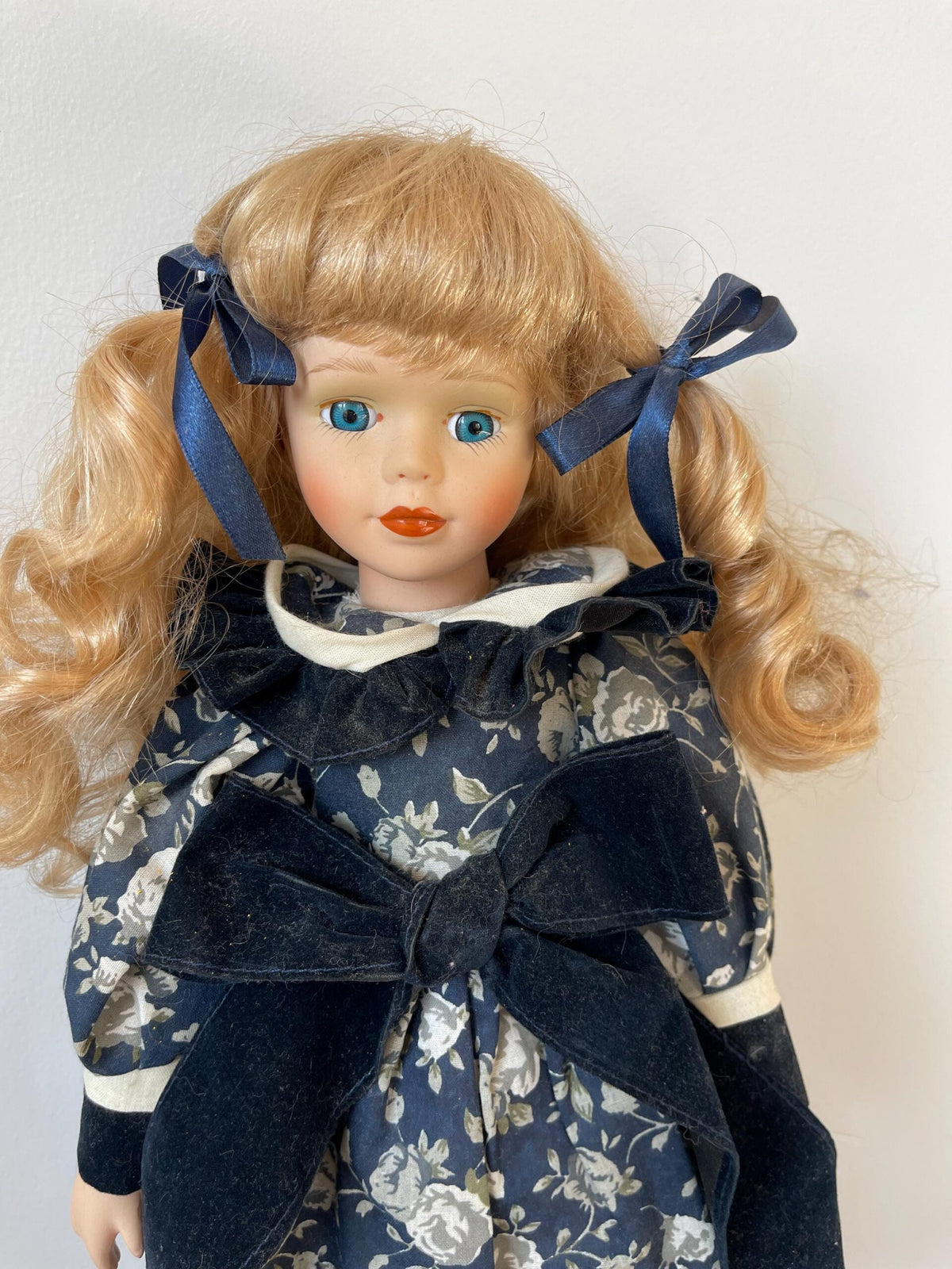 Vintage Porcelain Doll — Navy Floral Dress with Velvet Bow