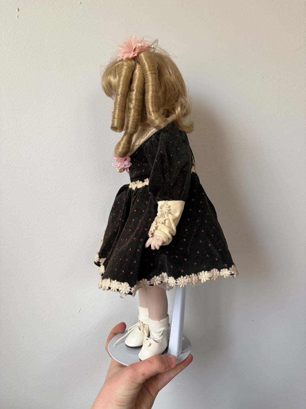 Vintage Porcelain Doll with Blonde Curls and Black Dress
