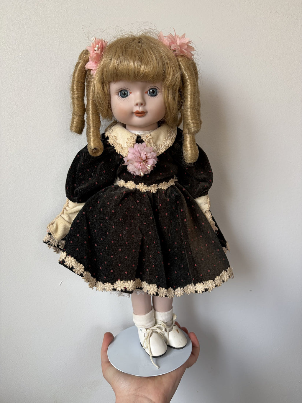 Vintage Porcelain Doll with Blonde Curls and Black Dress